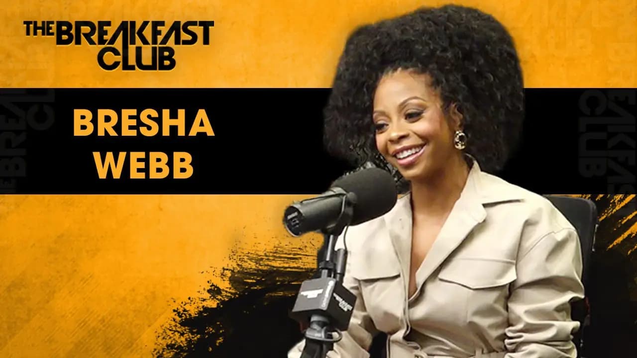 Bresha Webb smiling at the microphone on The Breakfast Club